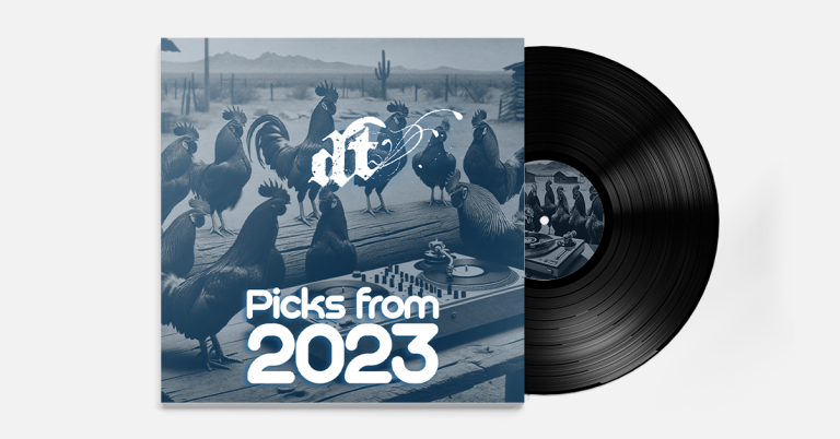 This image shows a vinyl record album cover for "Picks from 2023" by "nit." The cover features a surreal blue-tinted scene with several roosters and chickens gathered around a DJ turntable setup in what appears to be a desert landscape with cacti and mountains in the background. The "nit" logo appears at the top in white stylized text, while "Picks from 2023" is prominently displayed in large white letters at the bottom. A black vinyl record is partially visible extending from behind the album cover, and there appears to be a matching label on the record itself.