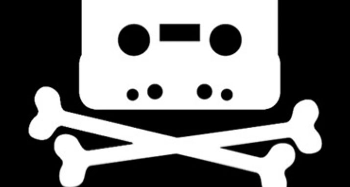 Pirate flag design with a cassette tape replacing the skull, crossed bones beneath it, white on black.