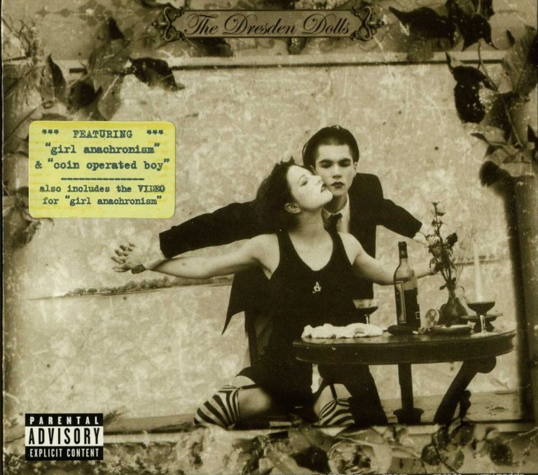 Album cover for *The Dresden Dolls* self-titled debut, featuring two performers in gothic theatrical poses at a dinner